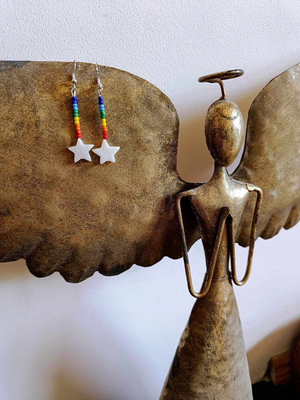 Rainbow Star Earrings with repurposed rainbow glass beads and white star-shaped shells on sterling silver ear wires.