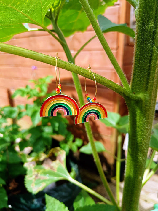 Rainbow Hoops earrings with colorful enamel rainbows and repurposed glass seed beads on gold-colored brass hoops.