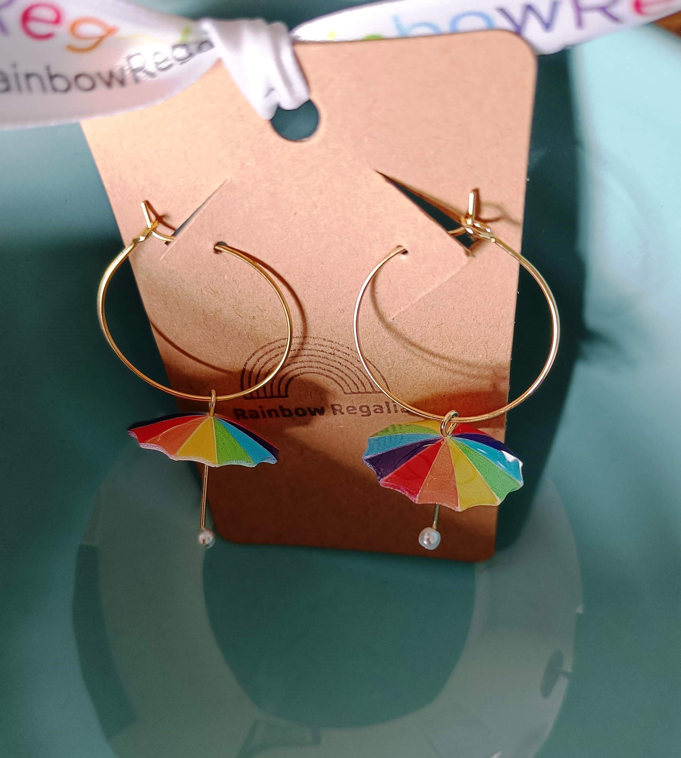 Rainbow umbrella hoop earrings with gold-colored brass, featuring colorful charm.