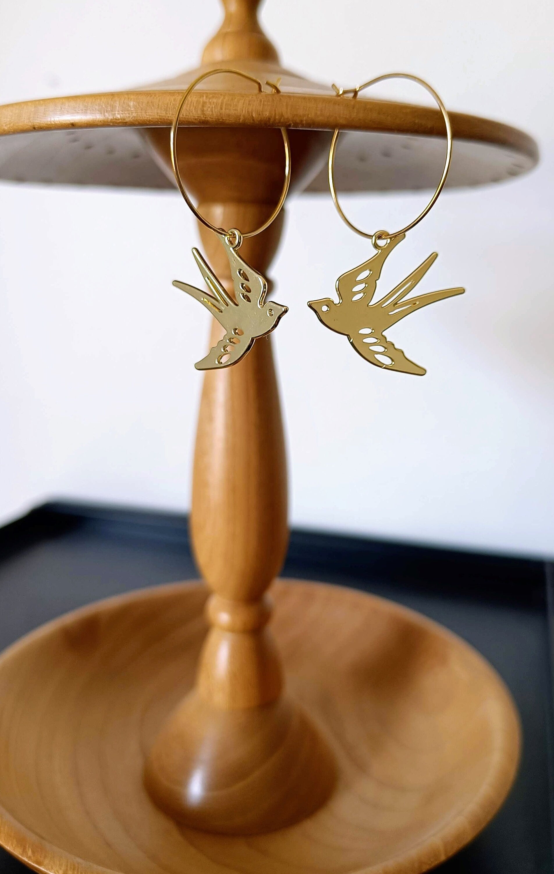 Gold-plated hoop earrings with swallow design.