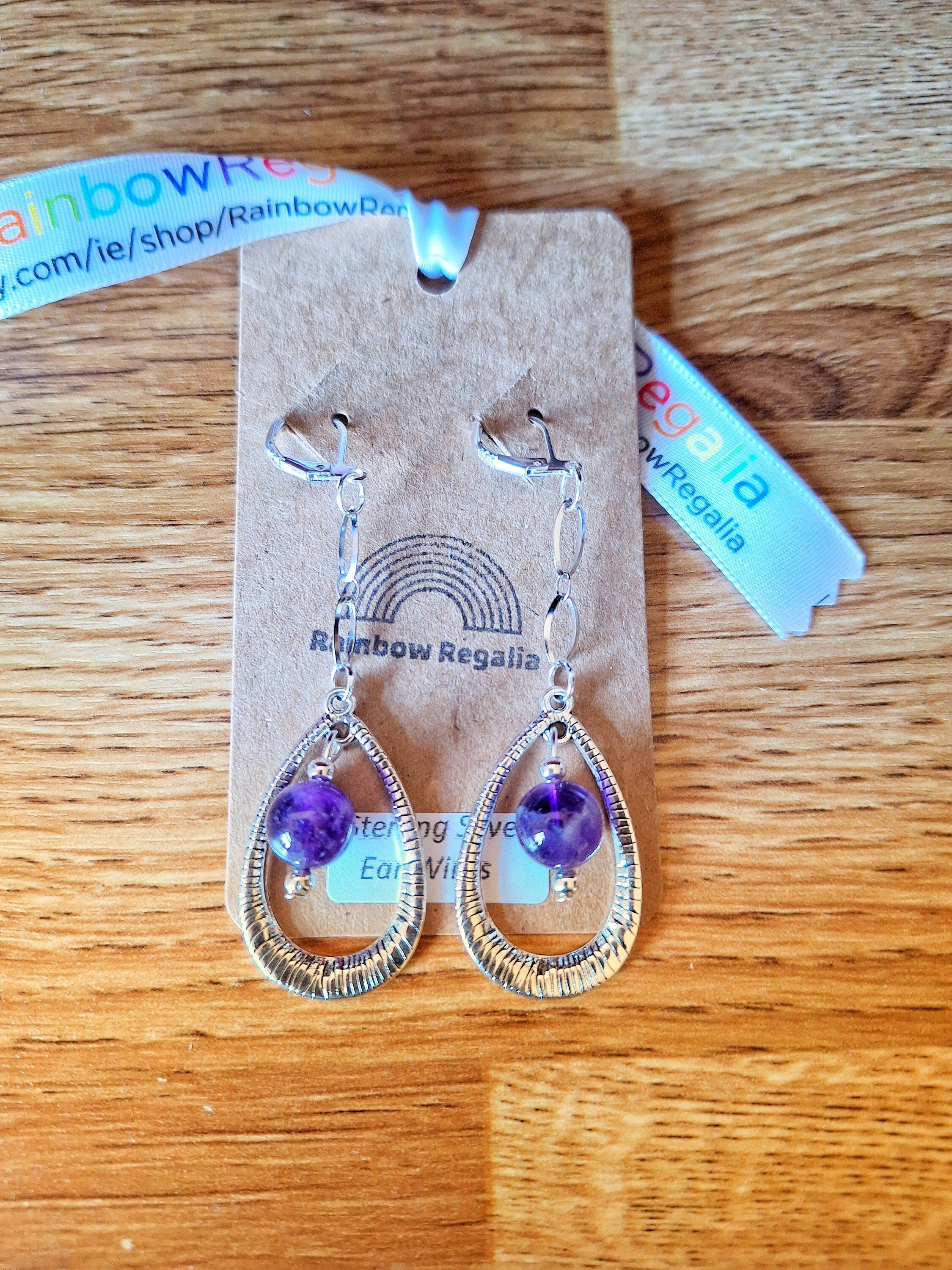 Elegant Iolanthe Drop Earrings with amethyst beads on stainless steel chain and teardrop pendant.