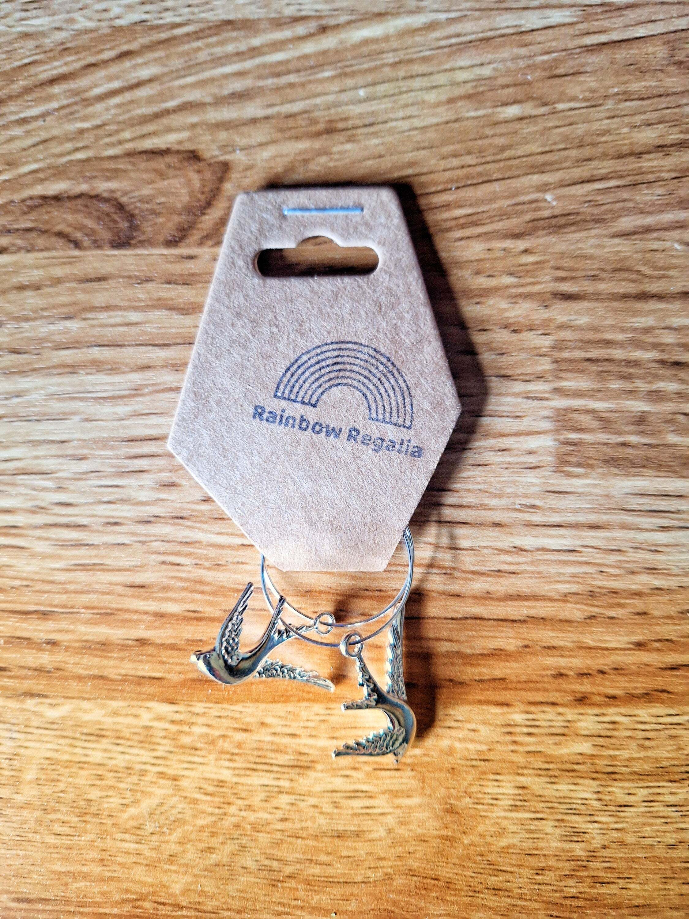 Silver Swallow Hoops with swallow charms on silver-colored brass, 25mm diameter.