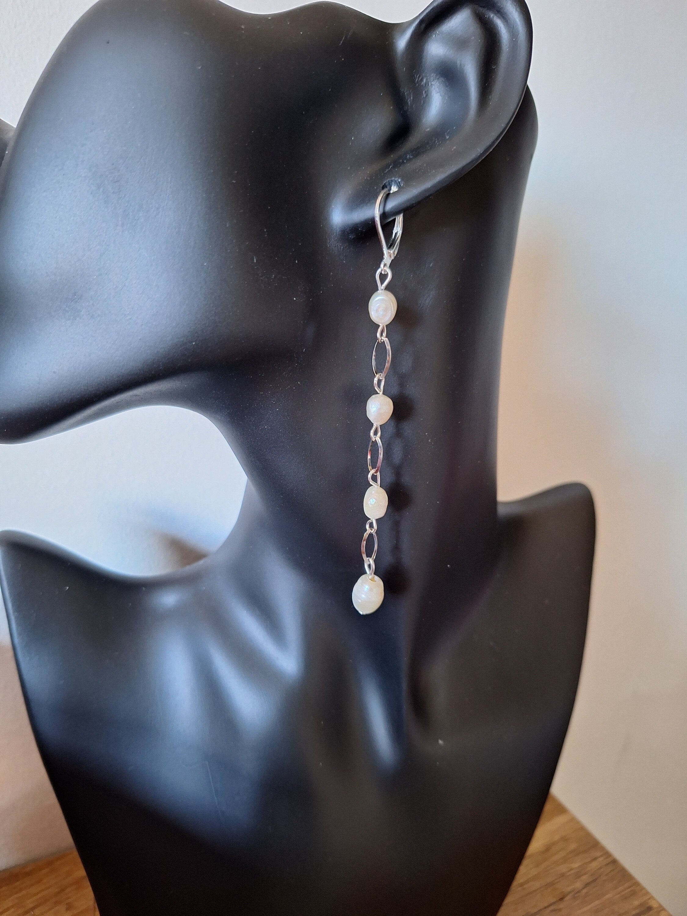 Vivienne Pearl Drop Earrings on display mannequin, showcasing long chain design with freshwater pearls in silver.
