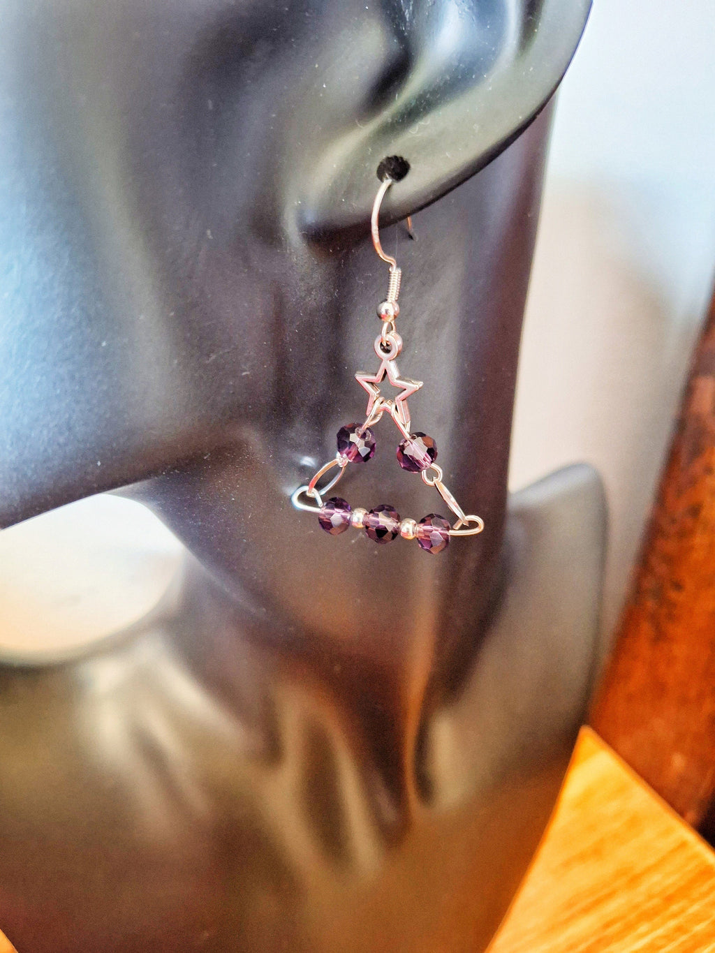 Eve Chandelier Earrings with purple glass beads and star detail, dangling from a sterling silver wire.