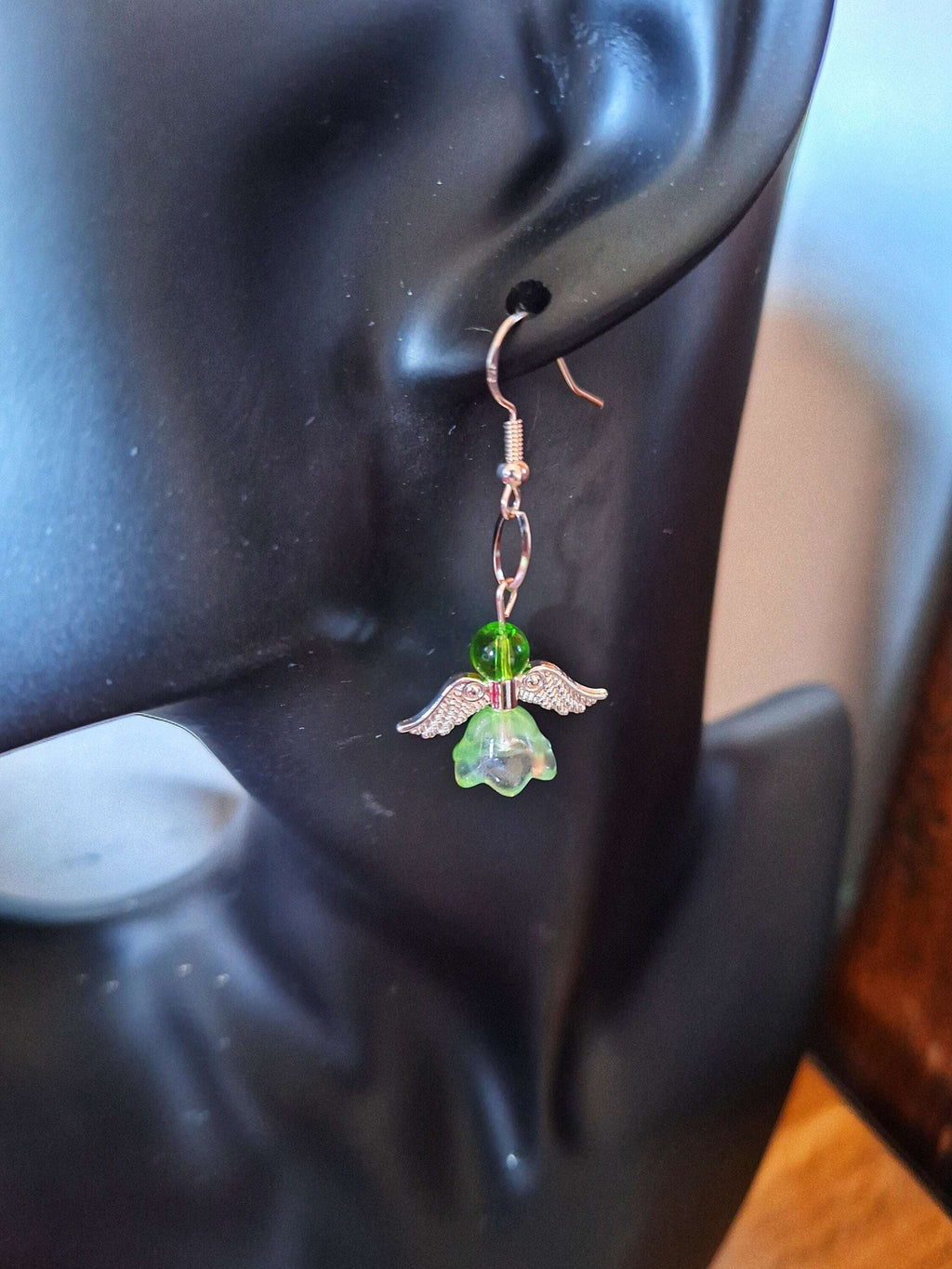 Angelica Silver Angel Earrings with green repurposed glass beads and sterling silver wires displayed on mannequin.