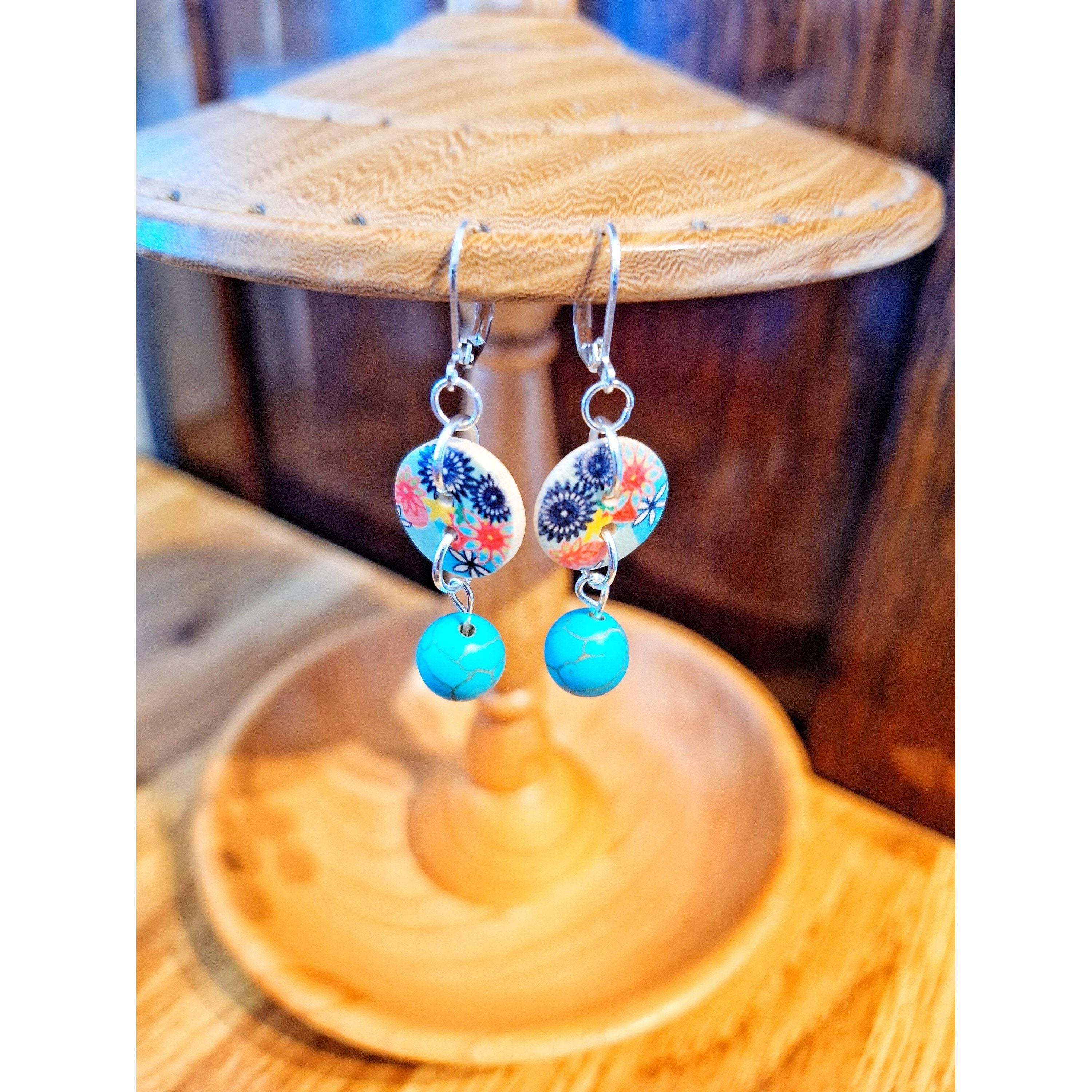 Earthy artsy Fleur Drop Earrings with turquoise stones, repurposed wooden buttons, and sterling silver lever-backs on wooden display.