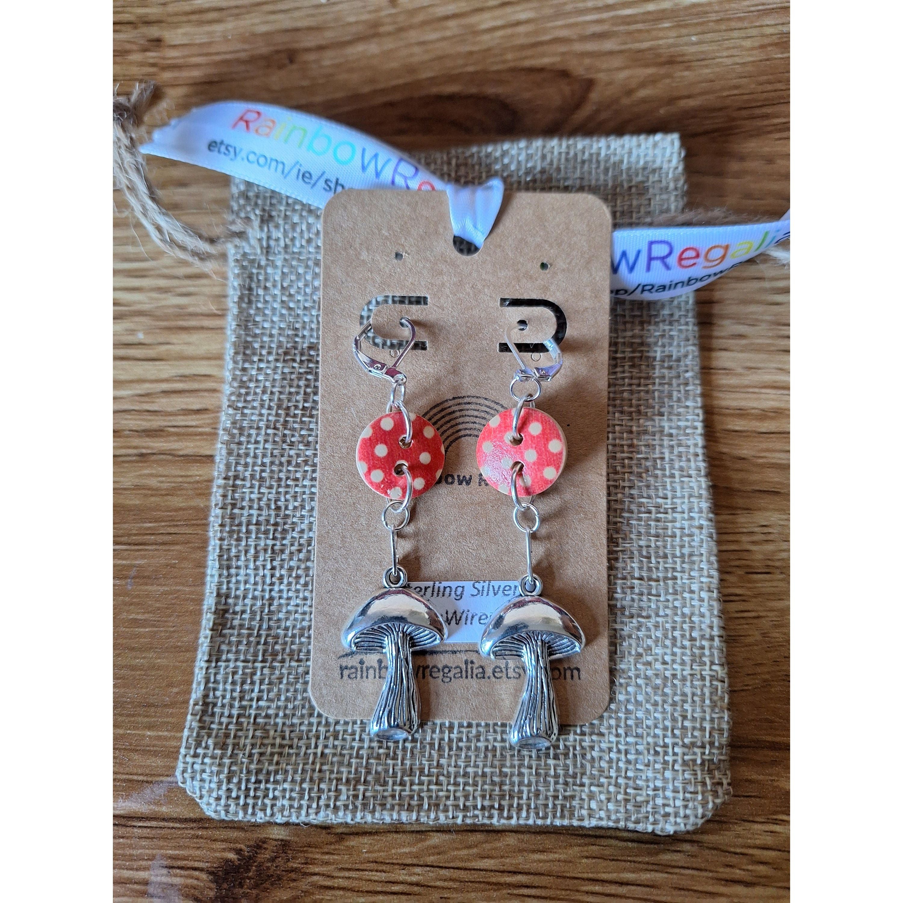 Auri Mushroom Earrings with repurposed wooden buttons and silver-plated accents, displayed on a rustic background.