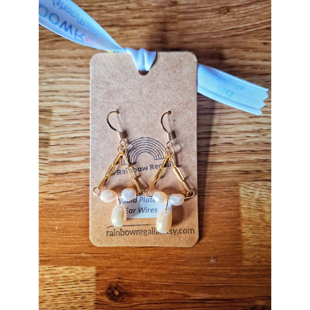 Victoria Pearl Earrings on display, featuring 50mm gold-plated chandelier design with repurposed freshwater pearls.