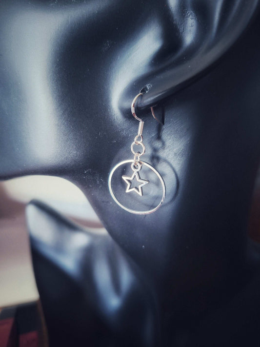 Vega Star Earrings with hollow star in 25mm circle, available in silver and gold, elegant and celestial-inspired design.