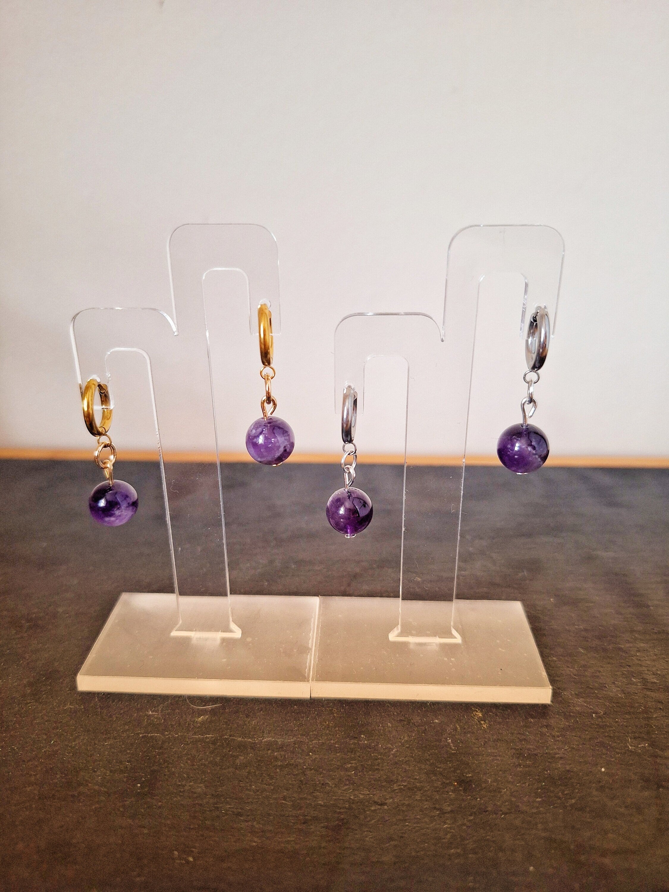 Lydia Amethyst Huggies with genuine amethyst beads on stainless steel and gold-plated hoops, showcasing elegant and versatile design.