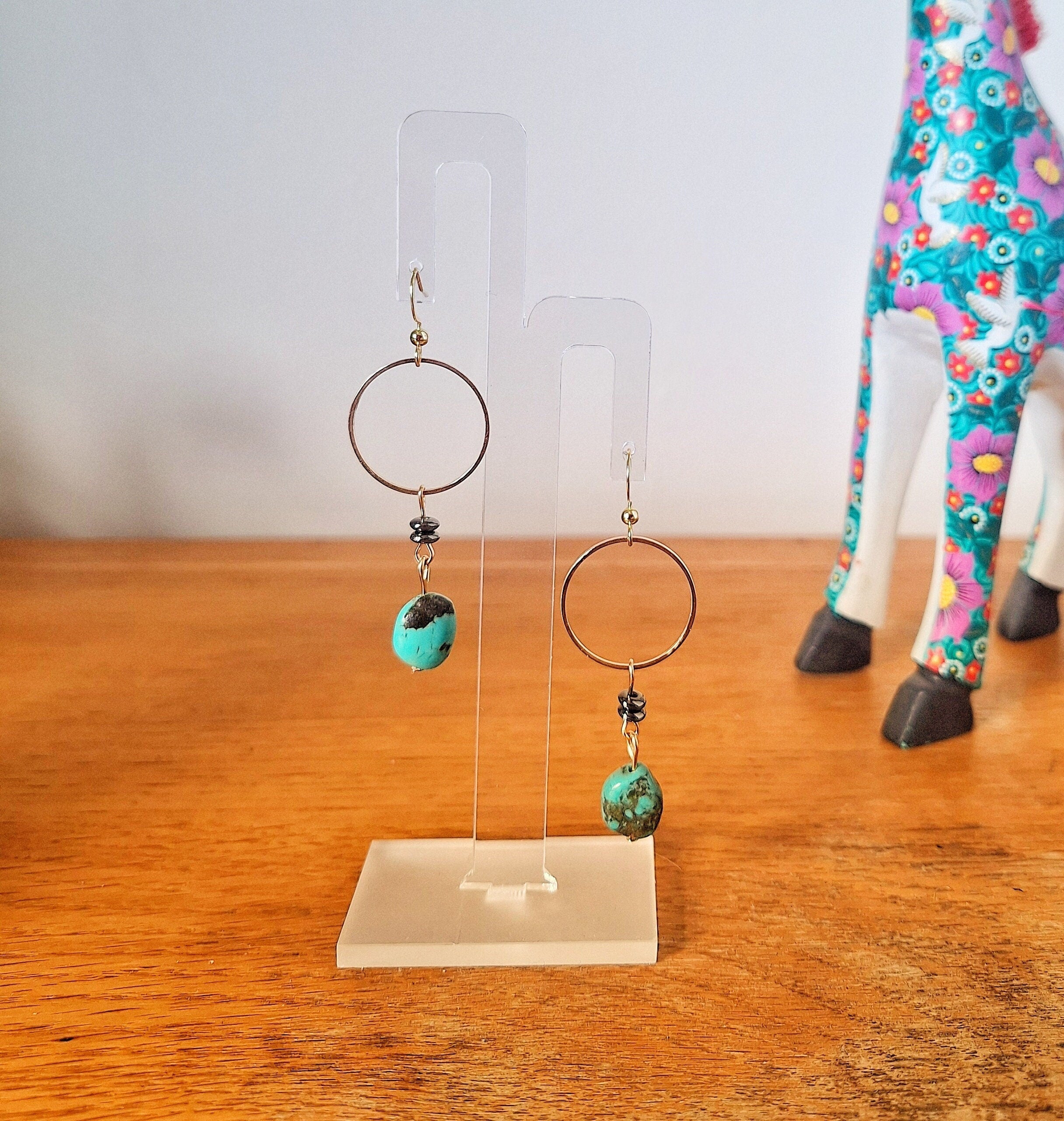 Sofia Turquoise Drop Earrings with gold-plated accents and sleek black mirrored discs on display.
