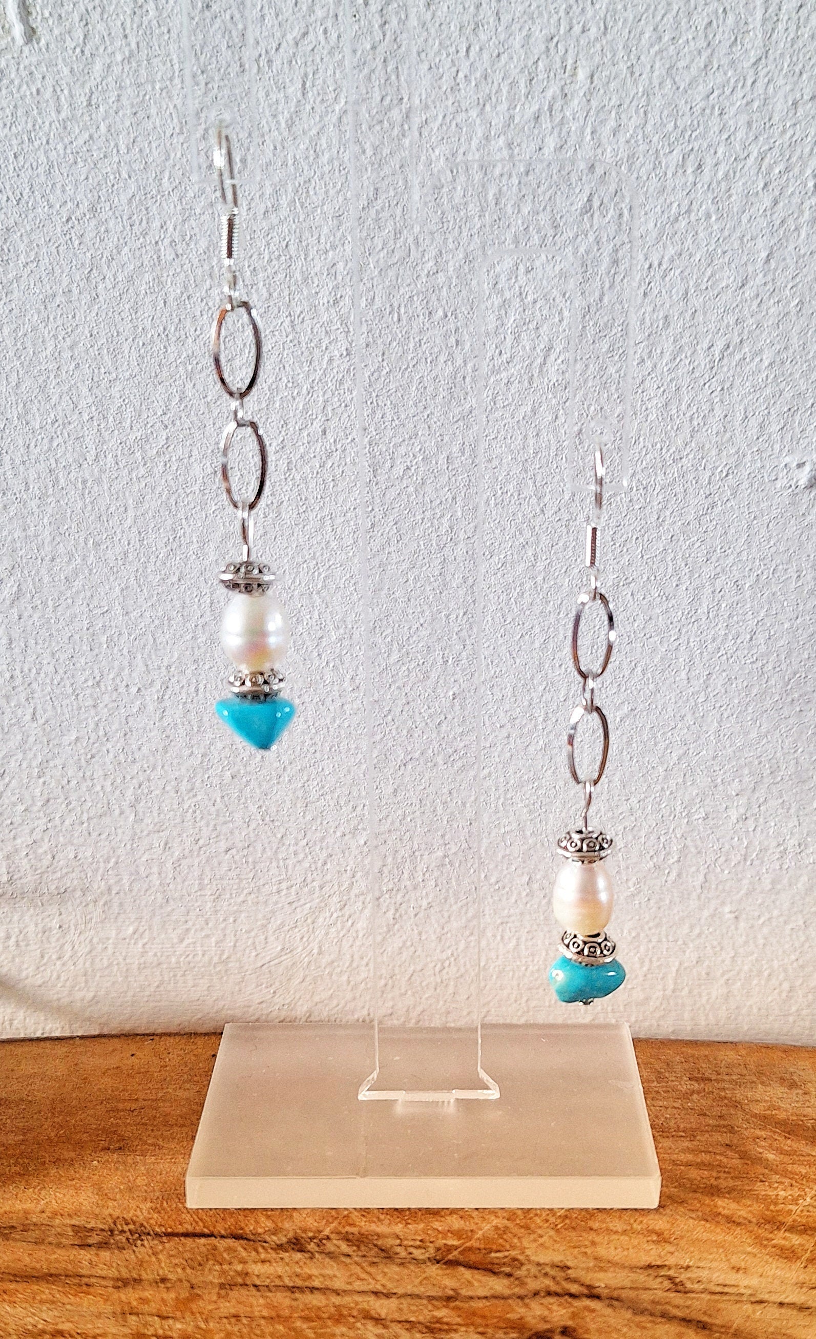 Arabella Turquoise and Pearl Earrings with sterling silver ear wires on display.