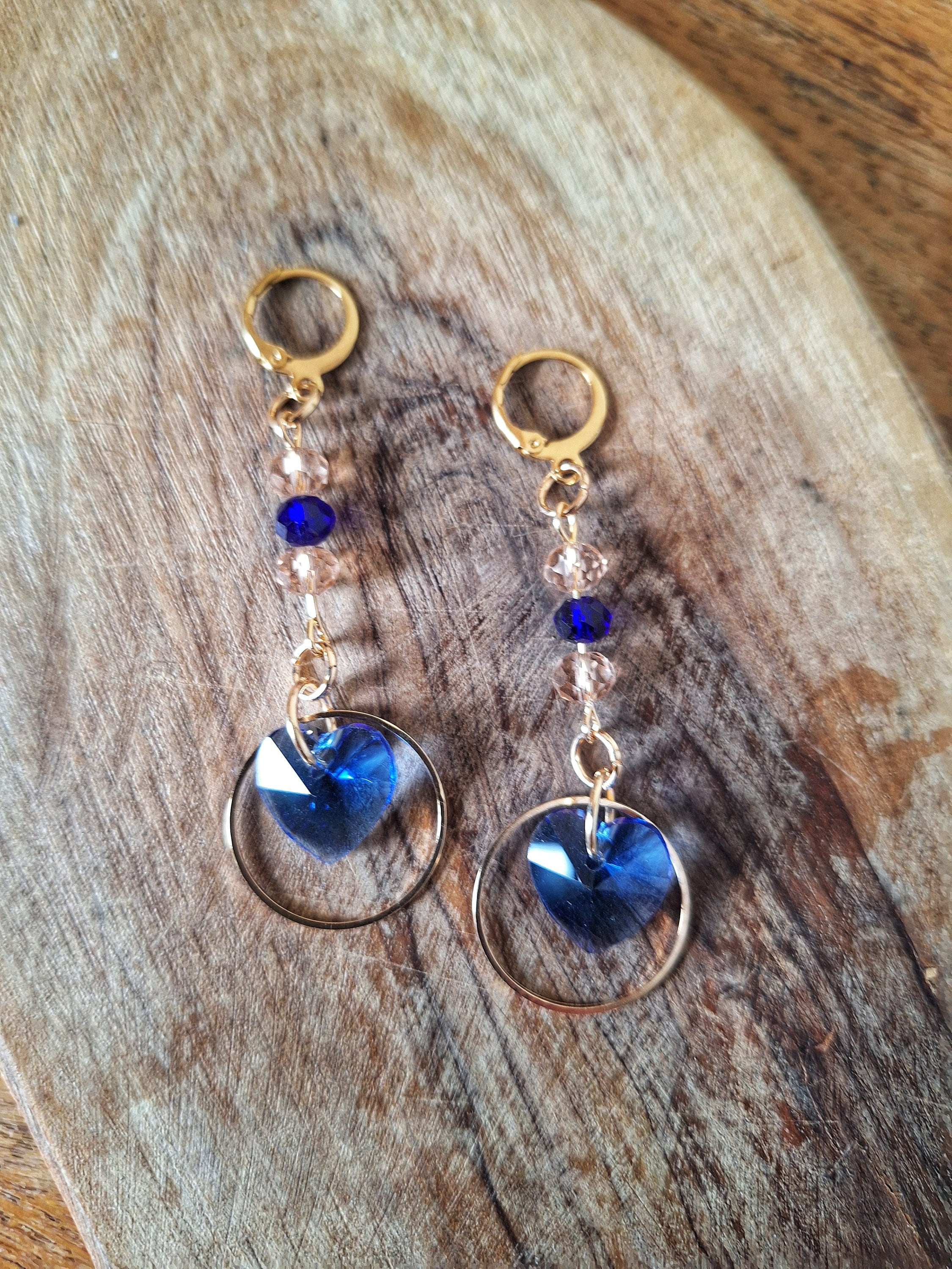 Amy Blue Heart Earrings with blue and pale pink glass beads, gold-plated huggie hoops, and heart-shaped design.