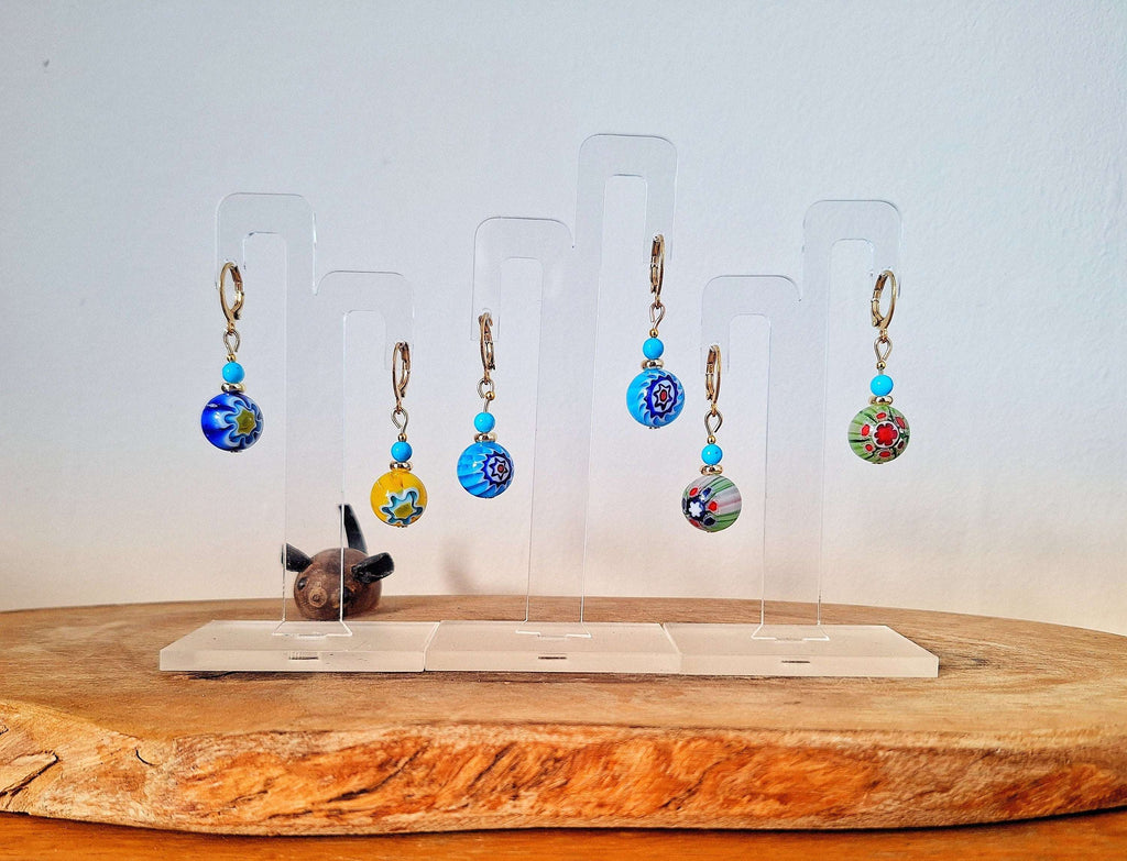 Millefiori Glass Bead Huggies with gold-plated accents on display stands.