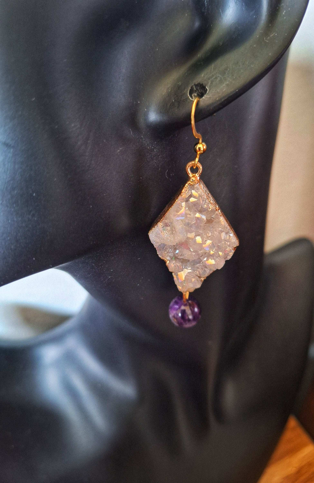 Aphrodite Quartz and Amethyst Earrings with gold-plated findings, on display.