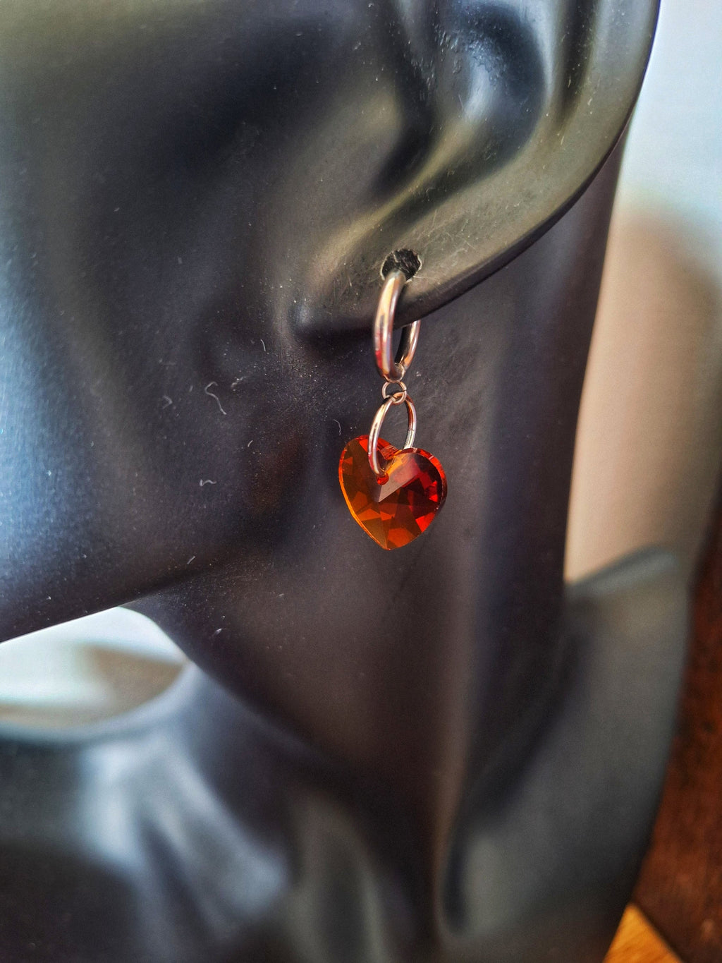 Venus Crystal Heart Huggies with faceted glass heart bead on stainless steel hoop.