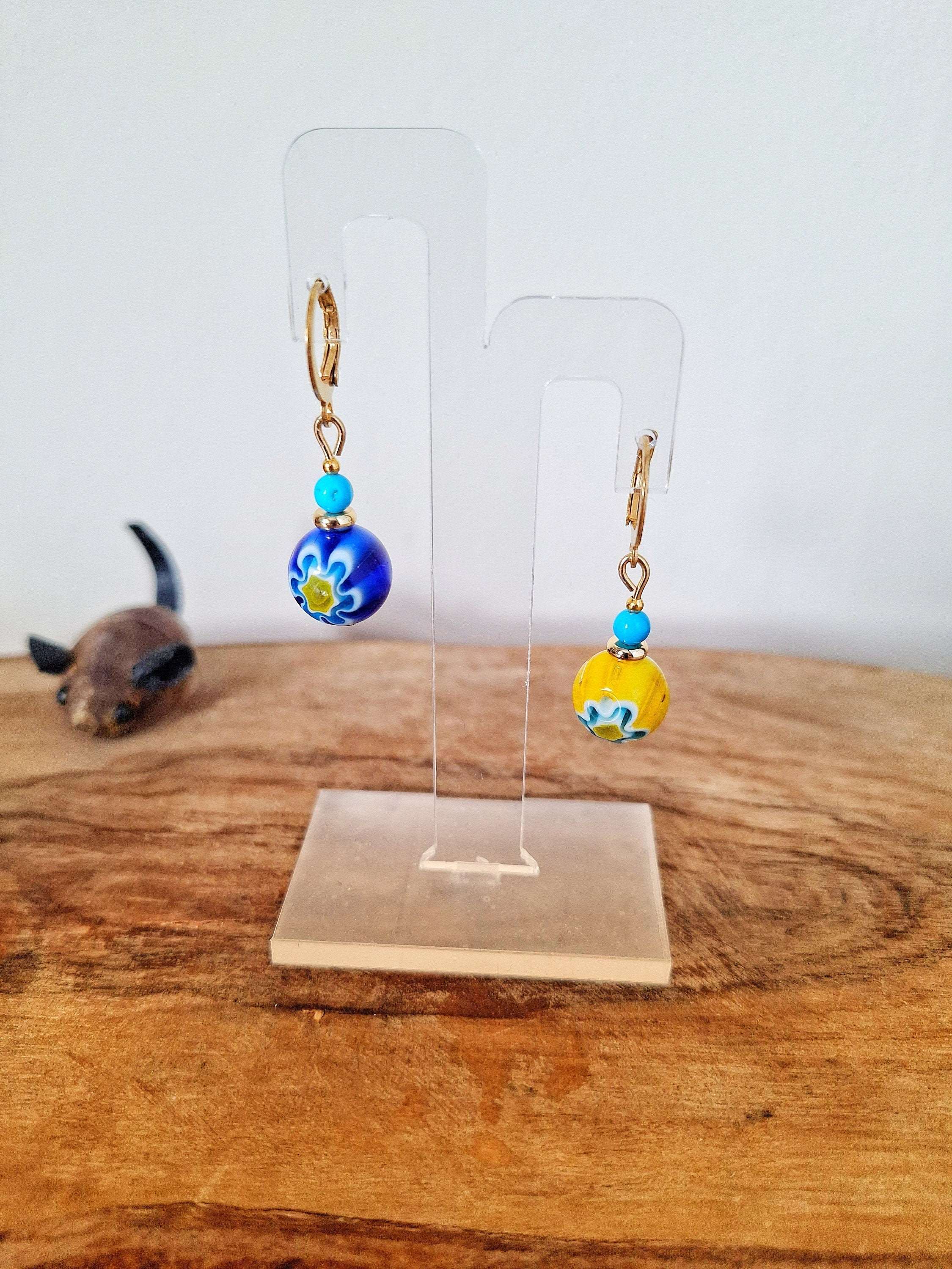 Millefiori Glass Bead Huggies with gold-plated accents on display stand.